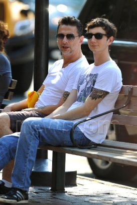 Dave Gahan and son wait on a bench in the West Village